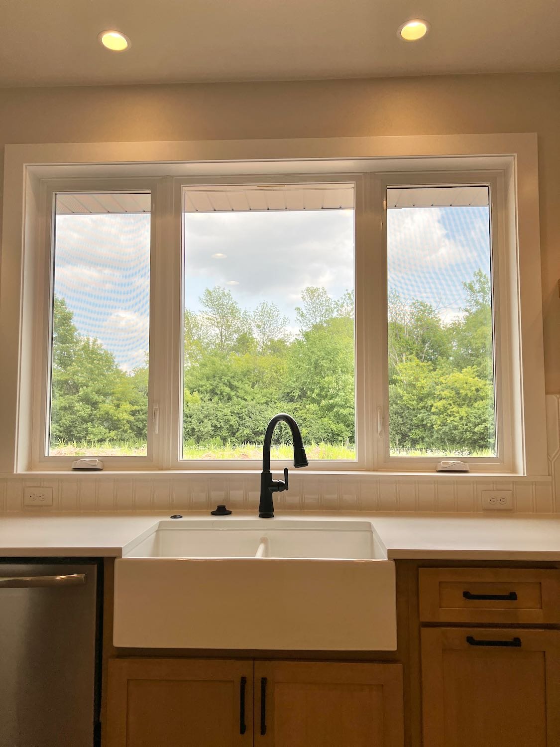 white apron sink with black faucet.