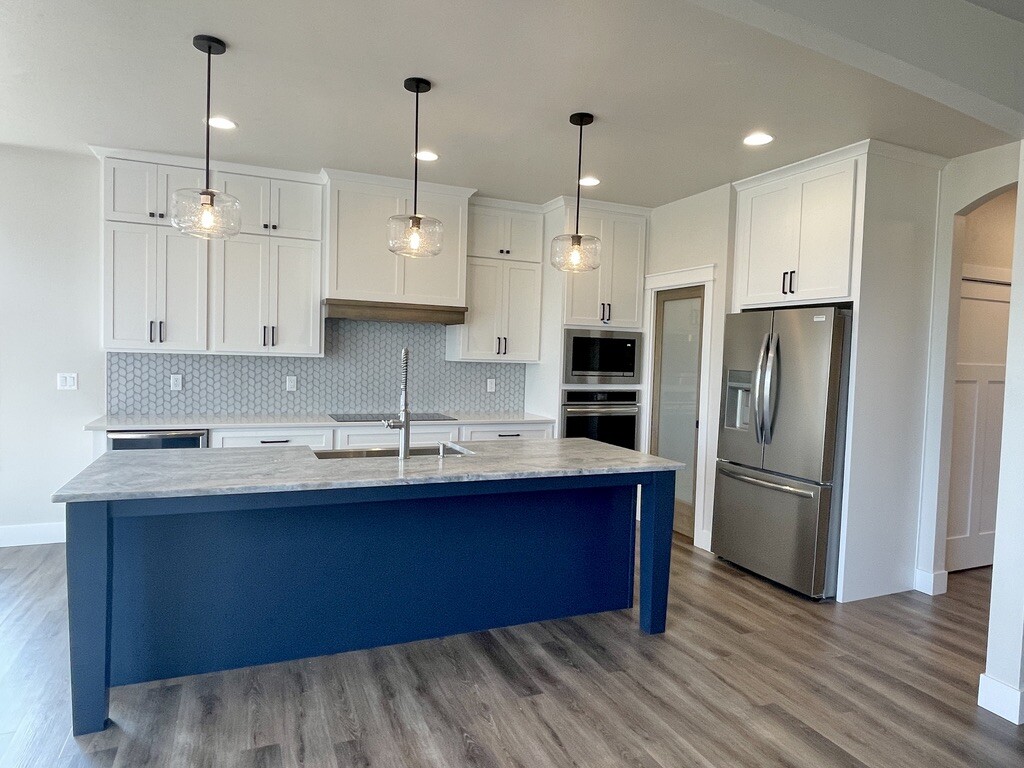 A modern kitchen with a blue island.