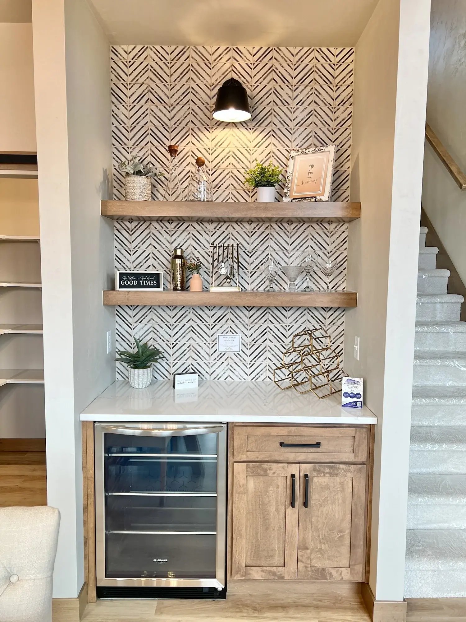 Beverage center with chevron wallpaper.