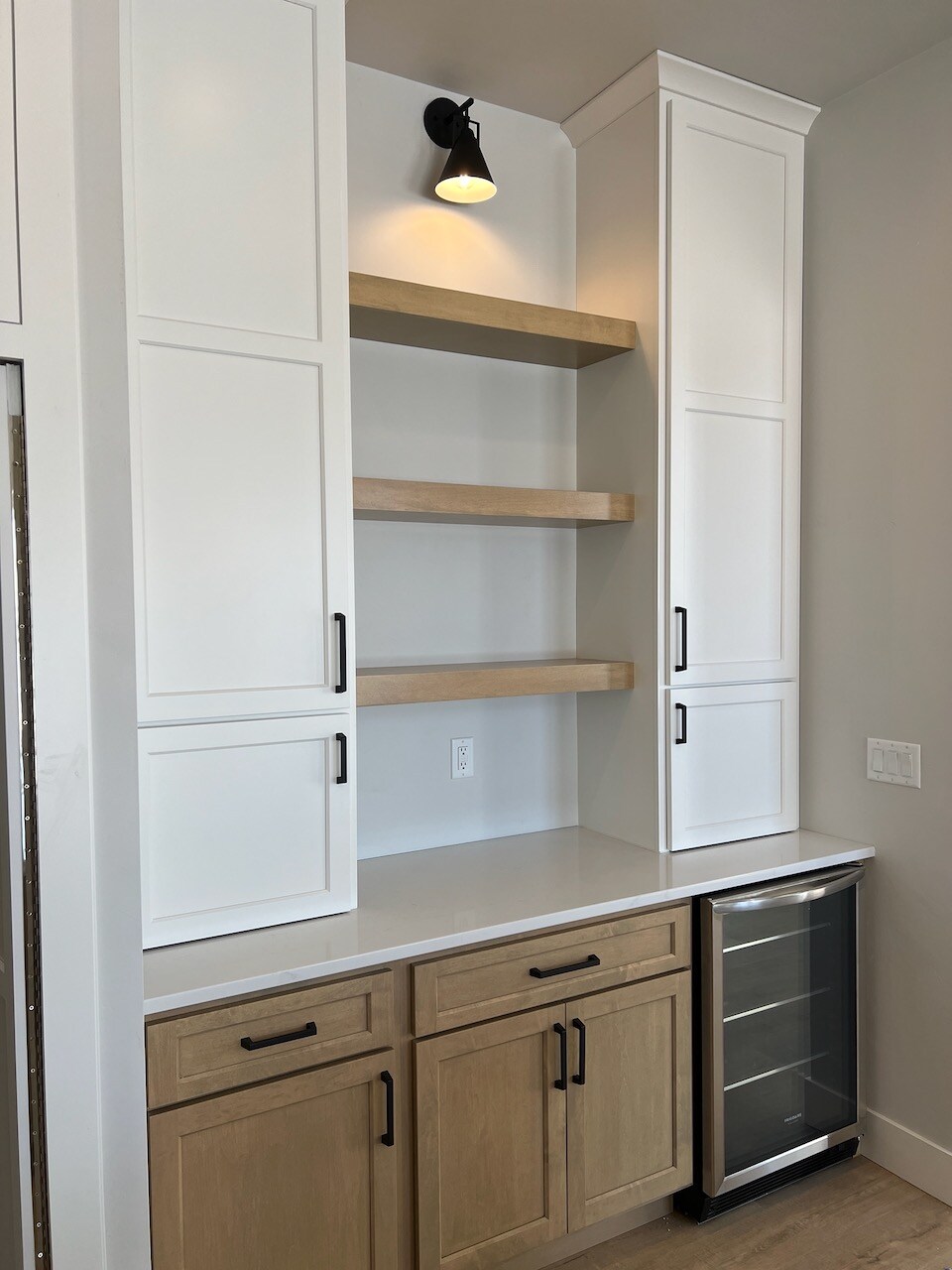 Beverage center with white cabinets.