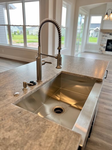 stainless steel kitchen sink with pull down faucet.