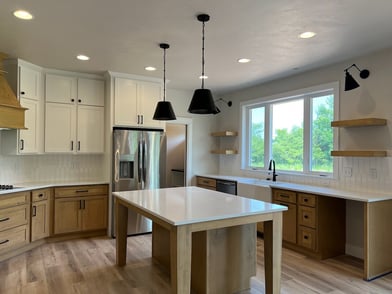 Kitchen Island with light wood base and white counter top.