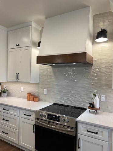 White range hood with wood accent.