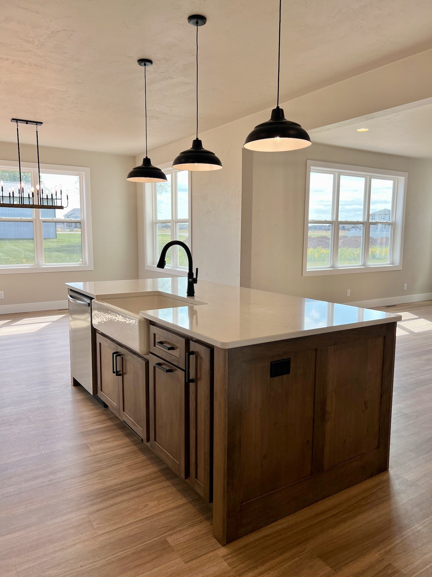 Oak wood kitchen island with white countertop.