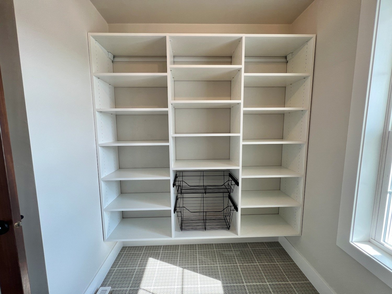 pantry with white shelves.