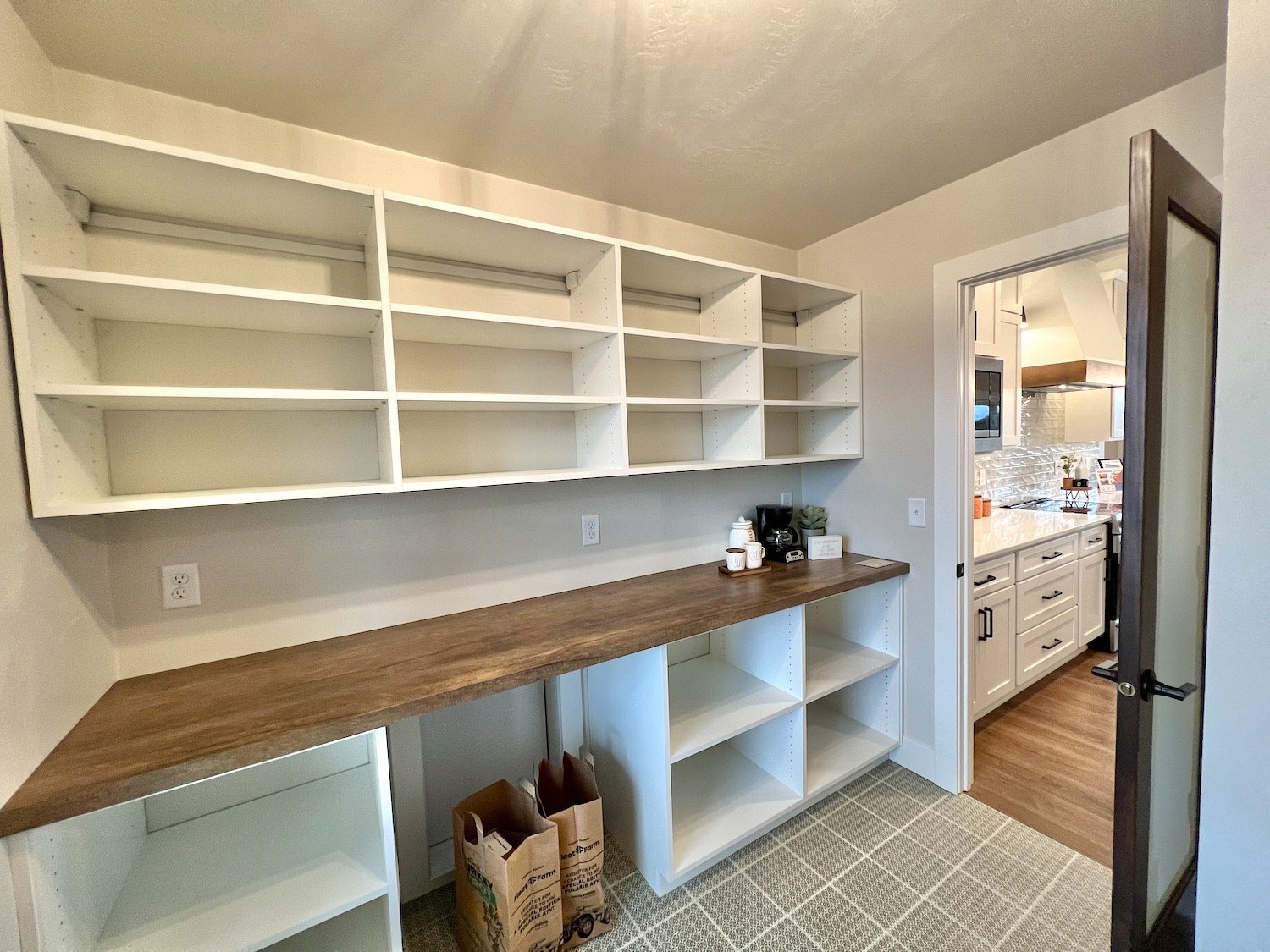 Walk-in pantry with grocery door.